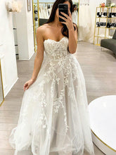 white strapless wedding dress with floral details