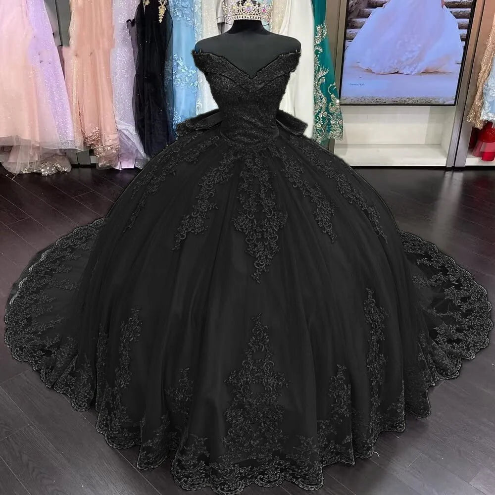 black quinceanera dress with floral lace applique and an off-shoulder neckline