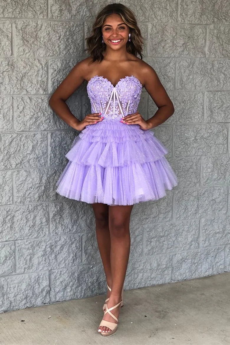 Woman wearing a lavender strapless hoco dress with ruffled layers